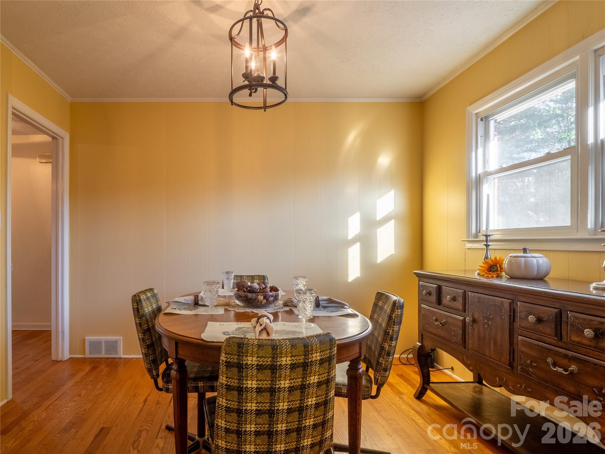 203 Oak Grove Road East Flat Rock, NC 28726 - Photo 9 of 24 a view of a dining room with furniture and chandelier