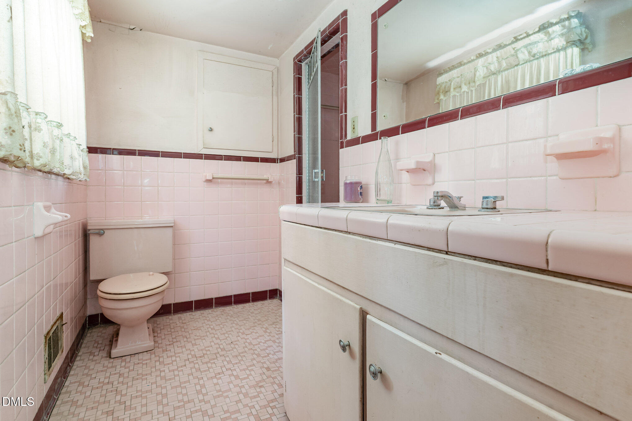 1312 Onslow Road Raleigh, NC 27606 - Photo 16 of 26 a bathroom with a sink a toilet and a mirror