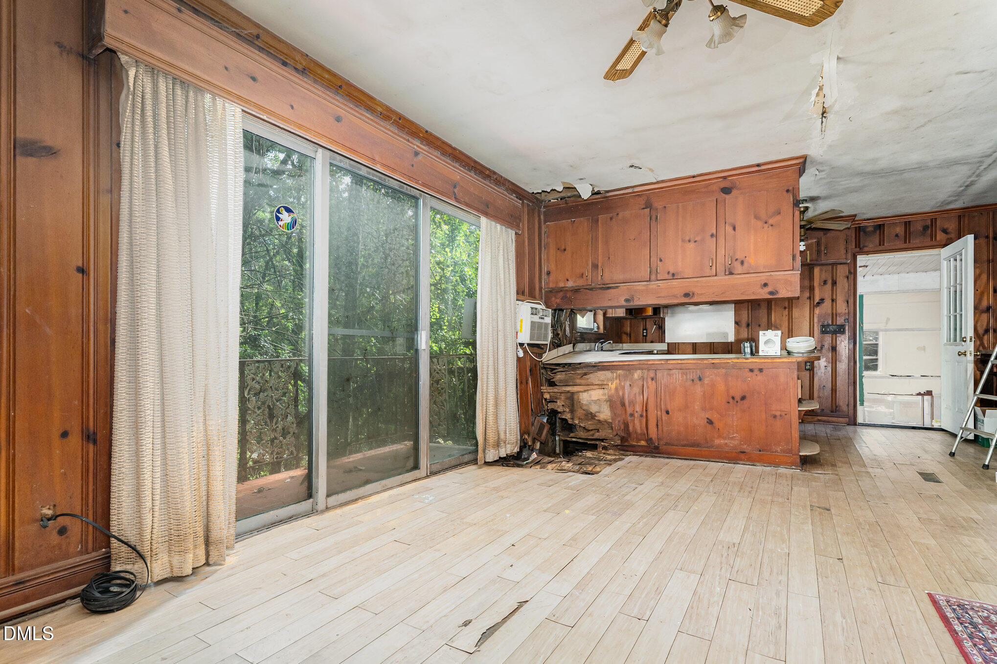 1312 Onslow Road Raleigh, NC 27606 - Photo 8 of 26 a kitchen with stainless steel appliances wooden floors and view of living room