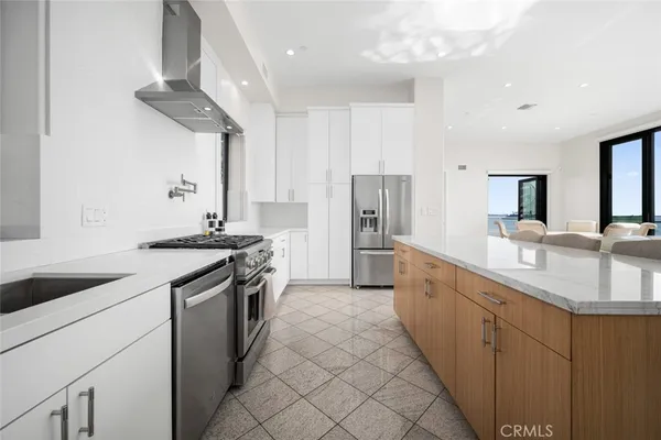 a kitchen with stainless steel appliances granite countertop a refrigerator and a sink