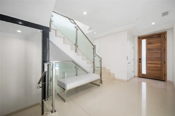 a view of entryway with wooden floor and stairs
