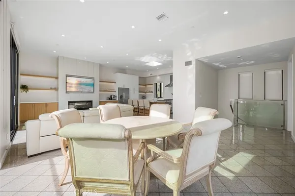 a living room with furniture a dining table and chairs