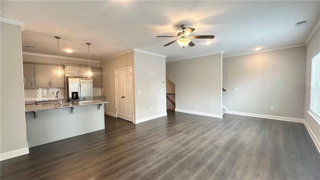 3092 Quantum Lane Atlanta, GA 30341 - Photo 18 of 44 a view of an empty room and kitchen with wooden floor