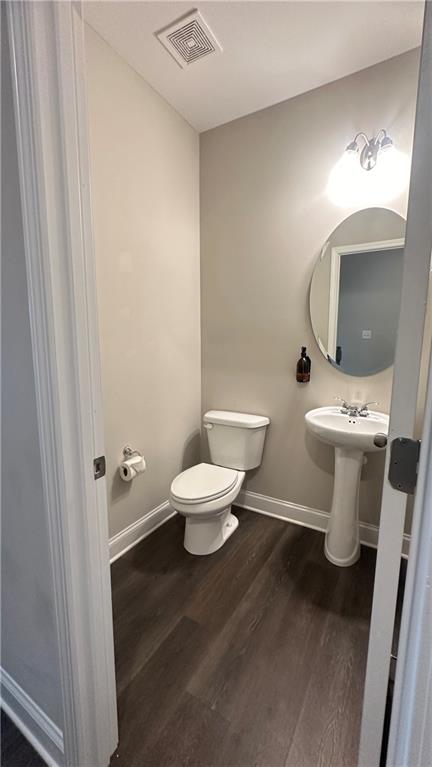 3092 Quantum Lane Atlanta, GA 30341 - Photo 7 of 44 a white toilet sitting next to a bathroom sink and a mirror