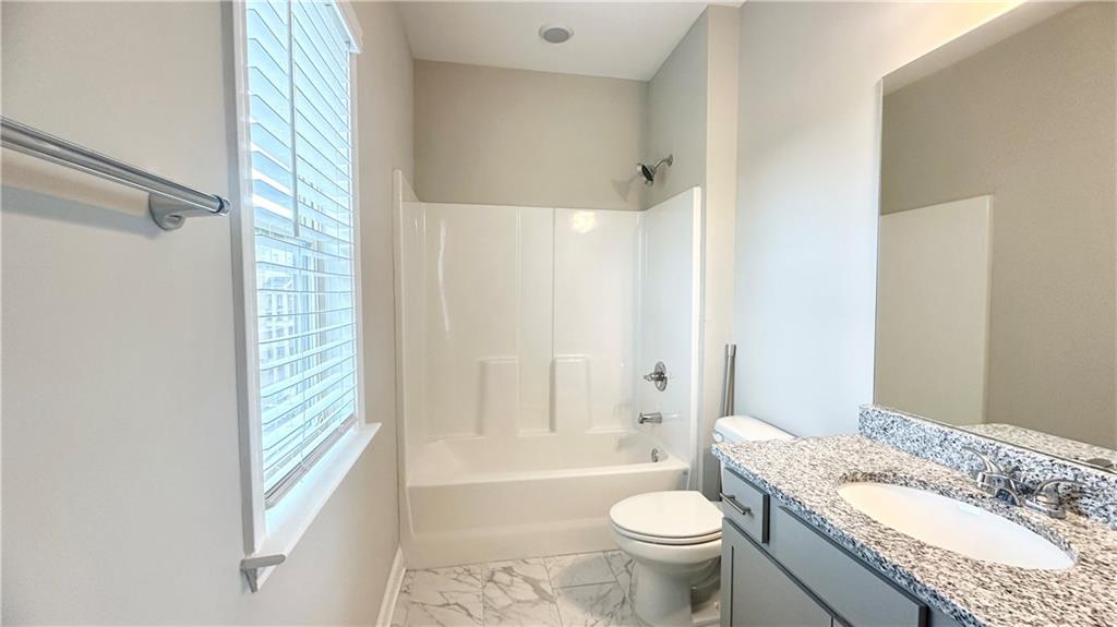 3092 Quantum Lane Atlanta, GA 30341 - Photo 10 of 44 a bathroom with a granite countertop toilet a sink and a bathtub