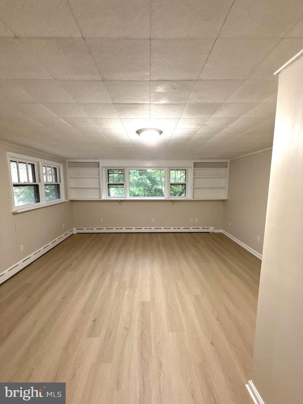 105 Atlantic Street, Unit F1 Bridgeton, NJ 08302 - Photo 3 of 9 an empty room with a empty space and windows