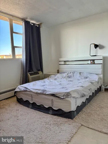 a bedroom with a bed and a large mirror