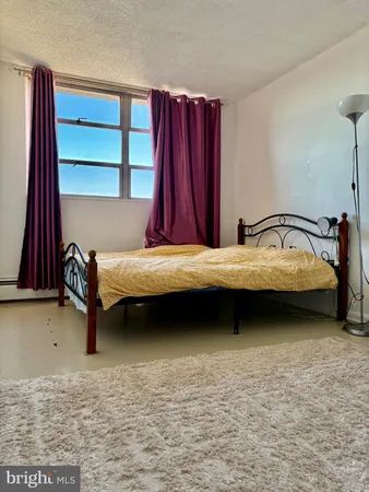 a bedroom with a bed and a desk