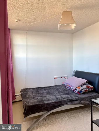 a bedroom with a bed and a night stand