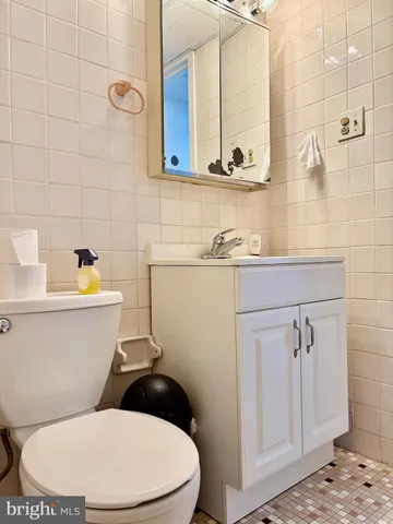 a white toilet sitting next to a bathroom sink