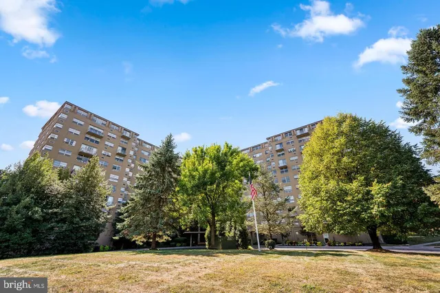 a view of a large building with trees in the background