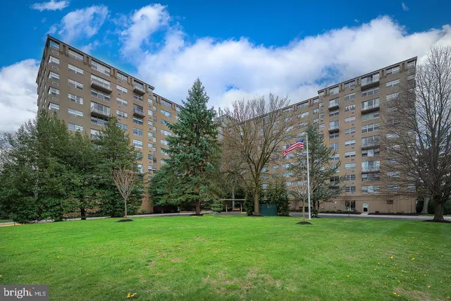 a view of a large building with a big yard and large trees