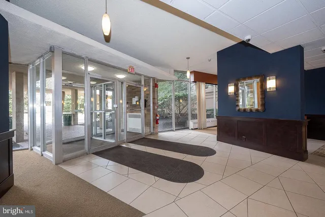 a spacious bedroom with a large bed and a chandelier