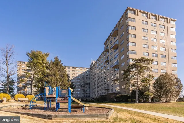 a view of a tall building next to a road