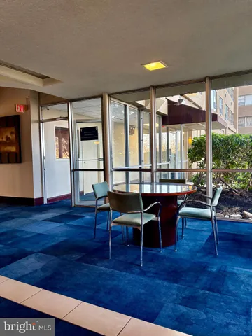 a view of living room with furniture and floor to ceiling window
