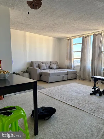 a living room with furniture and a lamp