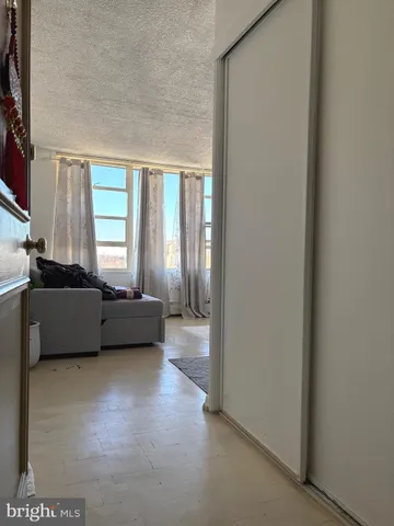 a living room with a couch a rug and a window