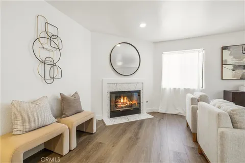 a living room with furniture a fireplace and a window