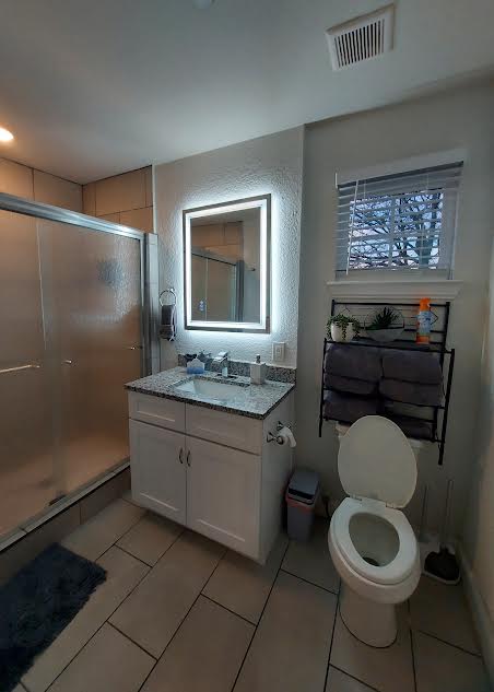 20202 McShepherd Road Georgetown, TX 78626 - Photo 28 of 40 Full bath featuring a stall shower, vanity, and light tile patterned floors