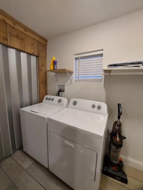 20202 McShepherd Road Georgetown, TX 78626 - Photo 30 of 40 Laundry room with separate washer and dryer and light tile patterned flooring