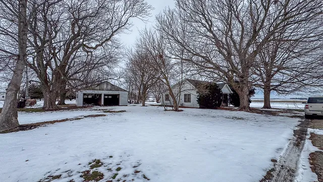 a view of a house with a snow on the road