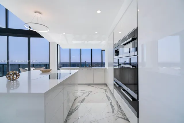a living room with stainless steel appliances kitchen island granite countertop furniture and a view of living room