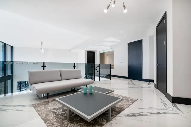 a living room with a large window and a table