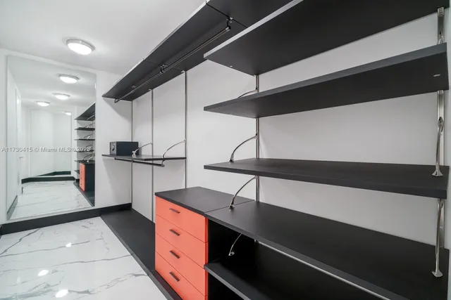 a bedroom with a bed couch and a large window