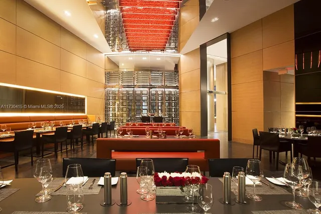 a living room with furniture and large windows