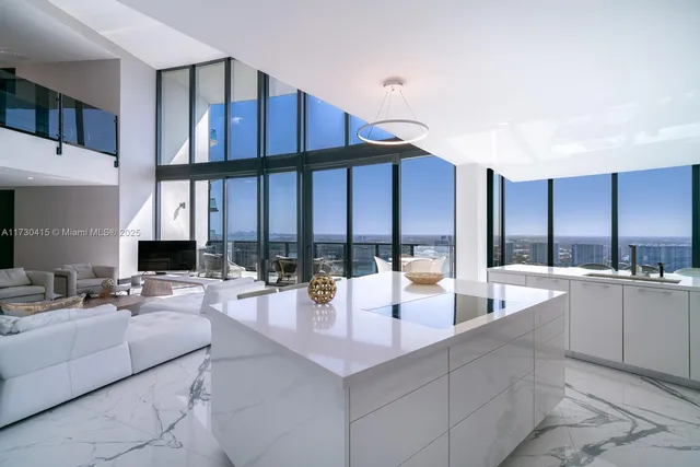 a large kitchen with kitchen island a large window in it