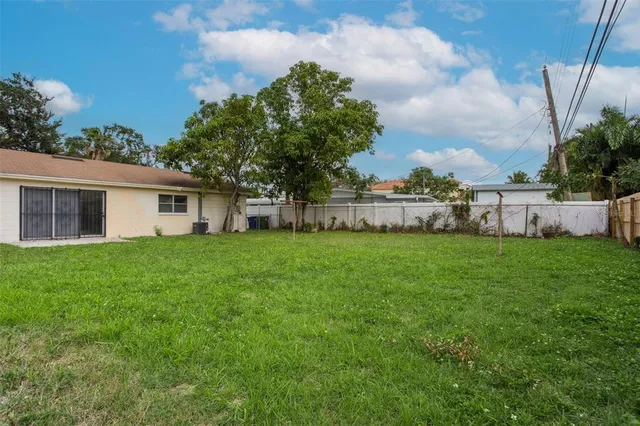 a view of house with backyard