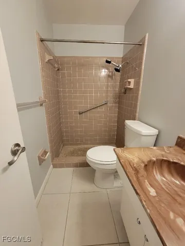 a white toilet sitting next to a bathroom sink