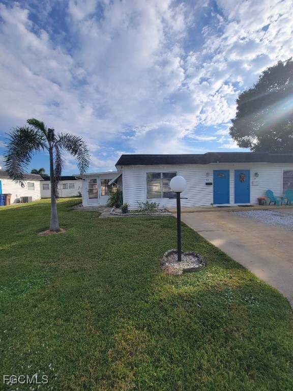 45 Tangelo Court Lehigh Acres, FL 33936 - Photo 2 of 19 a backyard of a house with table and chairs