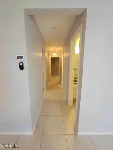 a view of a hallway with wooden shelves
