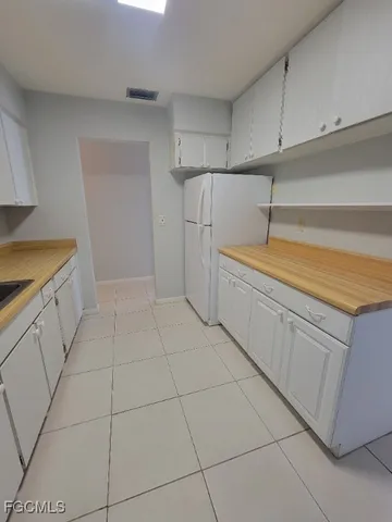 a view of a kitchen with cabinets