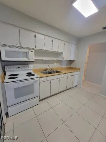 a kitchen with cabinets and appliances