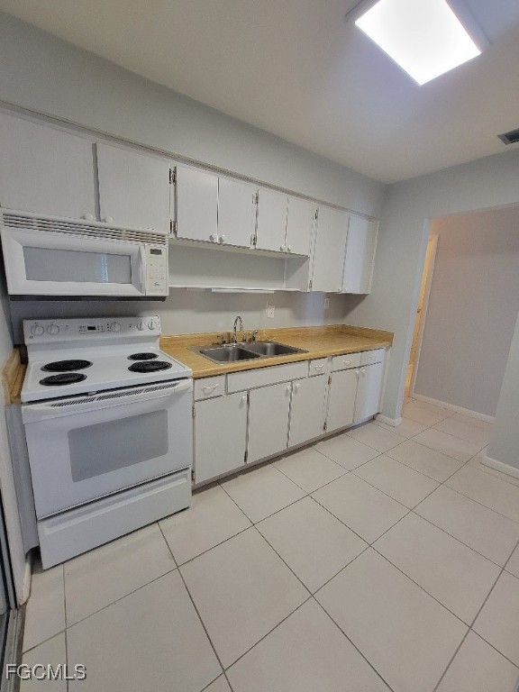 45 Tangelo Court Lehigh Acres, FL 33936 - Photo 8 of 19 a kitchen with cabinets and appliances