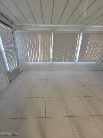 a view of an empty room and a window