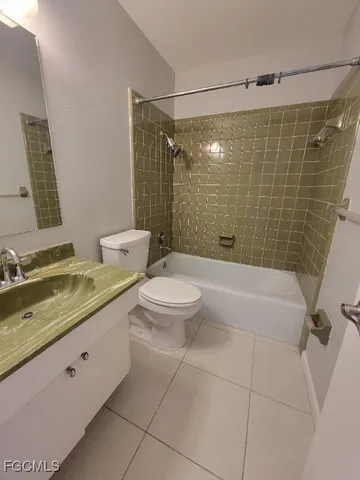 a bathroom with a granite countertop sink a toilet and shower