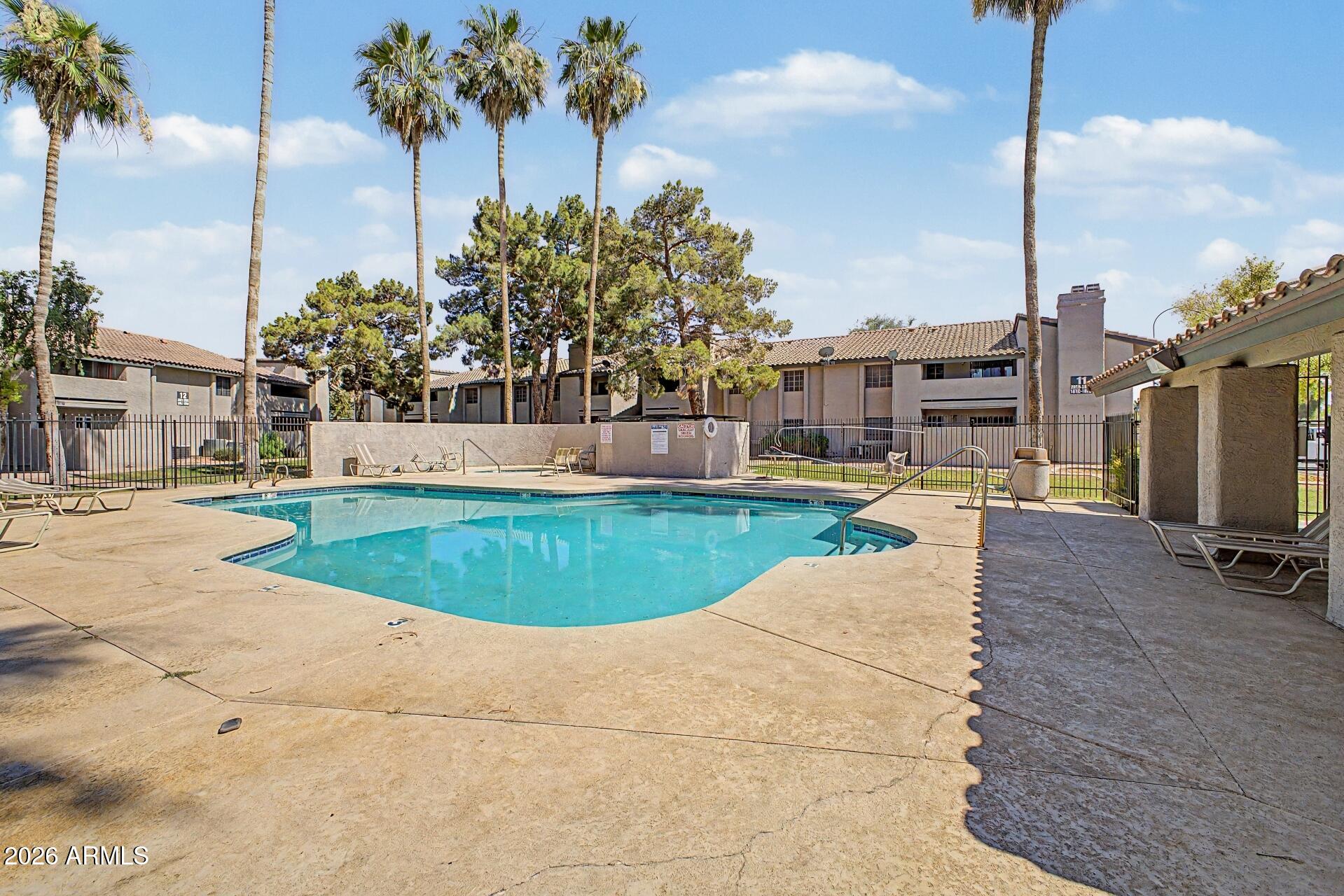 533 West Guadalupe Road, Unit 1104 Mesa, AZ 85210 - Photo 15 of 20 a view of a house with a swimming pool