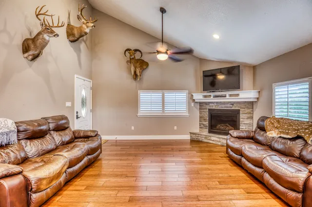 a living room with furniture a fireplace and a flat screen tv