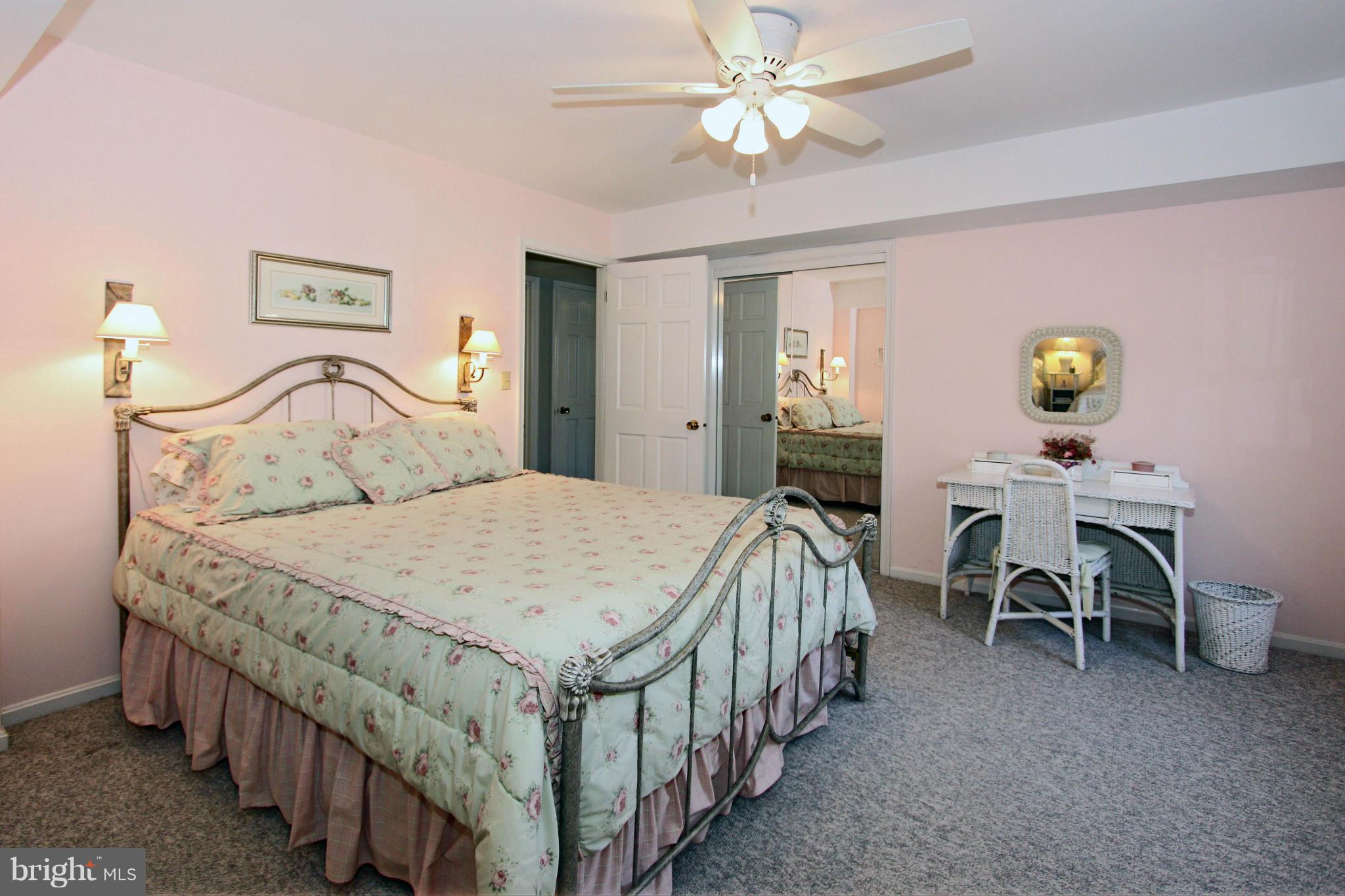11500 Drop Forge Lane Reston, VA 20191 - Photo 22 of 30 a bedroom with a bed and a chandelier