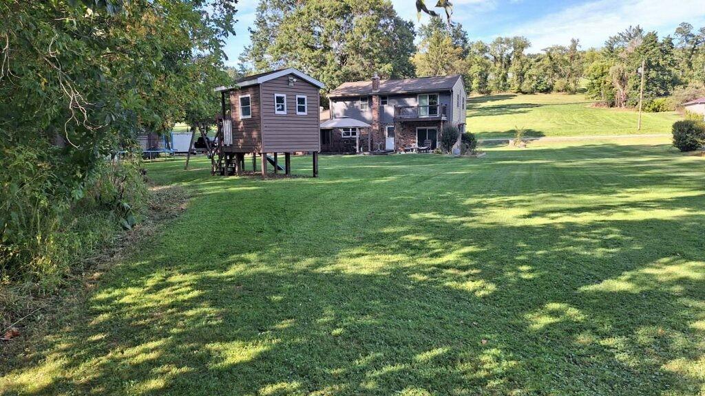 808 Lone Pine Road Amity, PA 15311 - Photo 5 of 38 a view of a house with a big yard and large trees