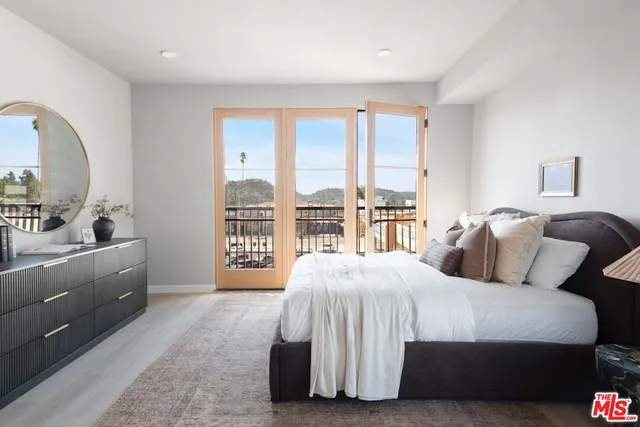 a bedroom with a large bed and a large window