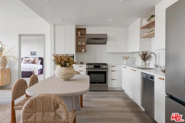 a kitchen with a table chairs stove and cabinets