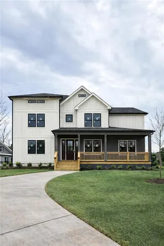 a front view of residential houses with yard and green space