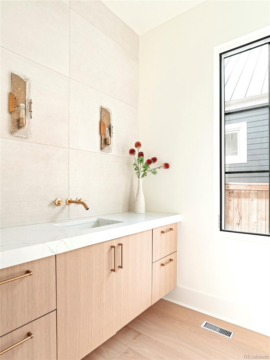 547 South Williams Street Denver, CO 80209 - Photo 14 of 50 a bathroom with a sink and a mirror