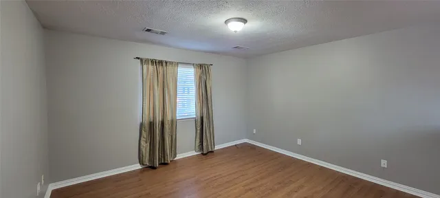 a bathroom with a granite countertop sink a toilet and a mirror