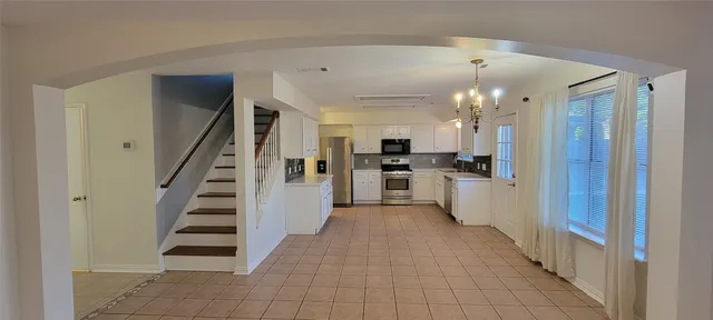 a view of a kitchen with wooden floor and electronic appliances