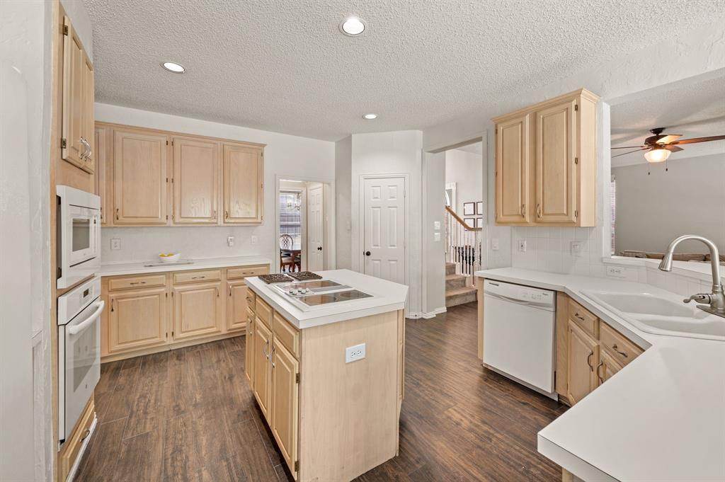 417 Shade Tree Circle Hurst, TX 76054 - Photo 12 of 39 a kitchen with stainless steel appliances granite countertop a sink stove and refrigerator